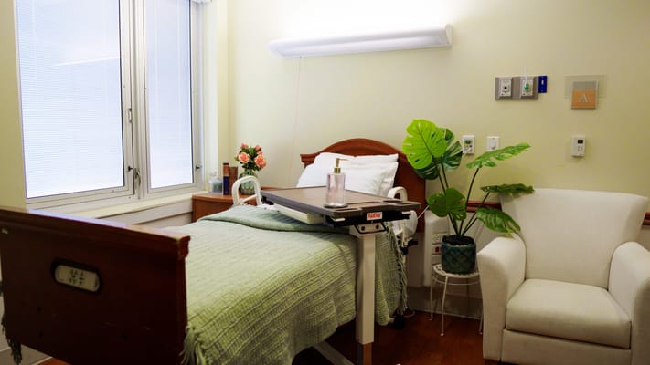 Cozy resident room with a bed and chair