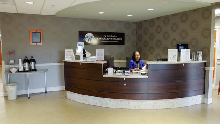 Reception area with staff member at the front desk