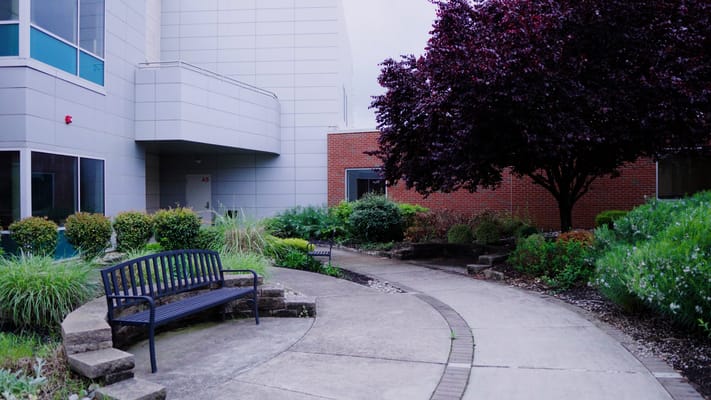 Garden path with benches and lush landscaping
