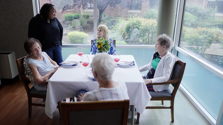 Residents enjoying drinks at a dining table