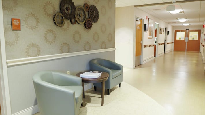 Hallway with seating area and decor on the walls
