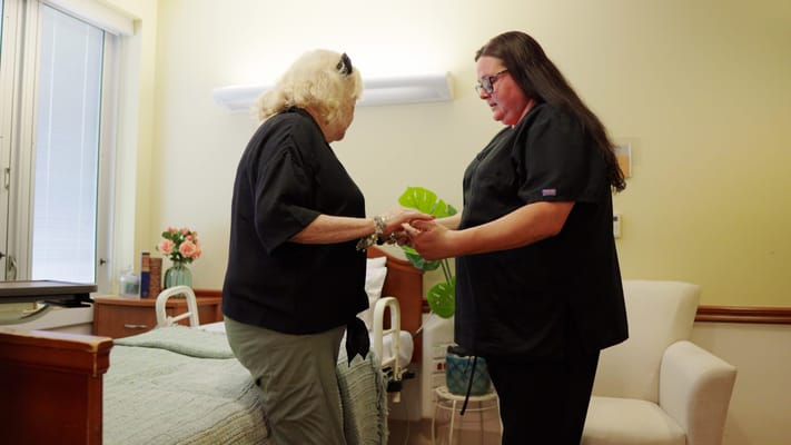 Caregiver assisting resident in a cozy room