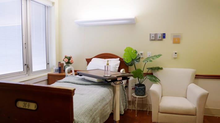 Cozy resident room with bed and chair