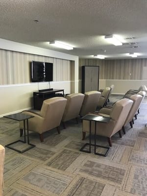 Common area with seating and television in a senior living facility