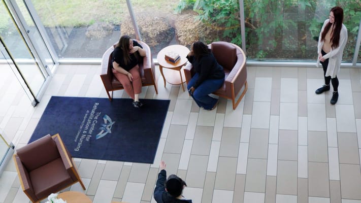 Residents and staff in a welcoming common area
