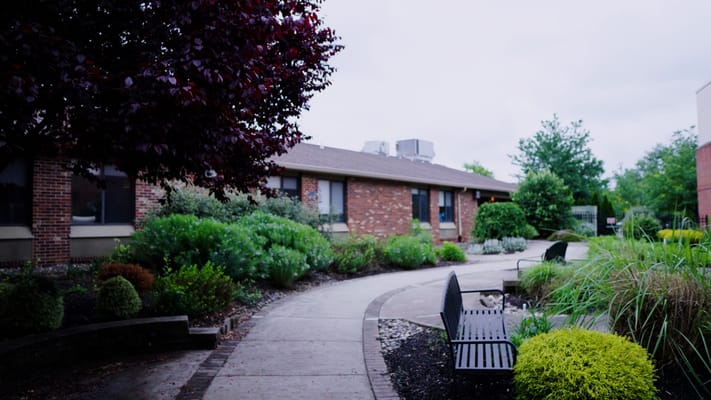 Pathway through landscaped garden at a senior living facility