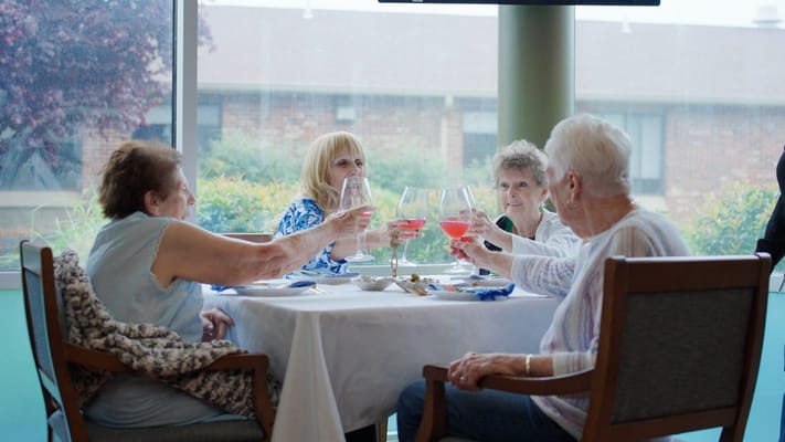 Residents enjoying drinks with a view in the lounge