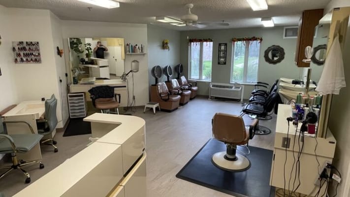 Beauty salon area with salon chairs and mirrors