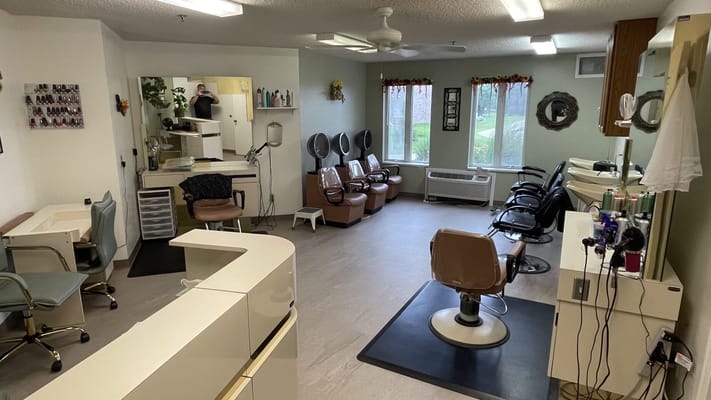 Beauty salon area with salon chairs and mirrors