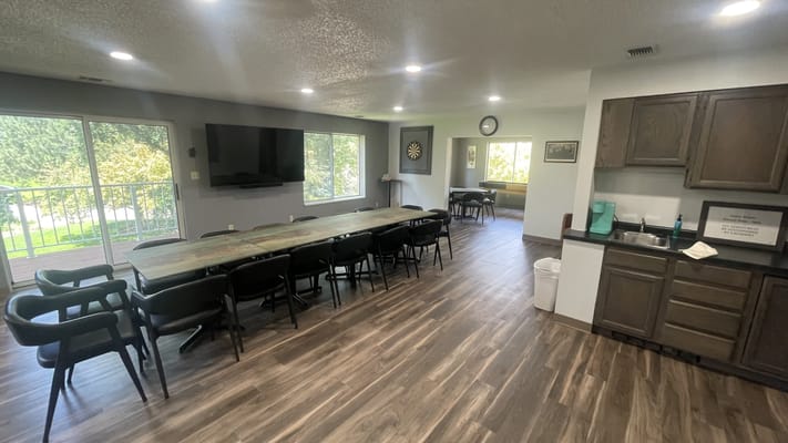 Bright common area with large table and seating