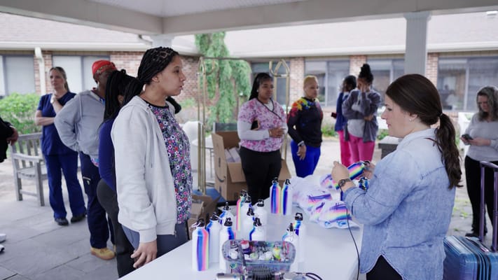 Residents and staff engaging in an outdoor craft activity