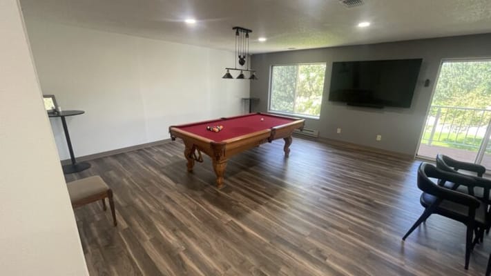 Game room with a pool table and seating