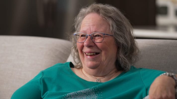 Smiling resident enjoying time in a cozy setting