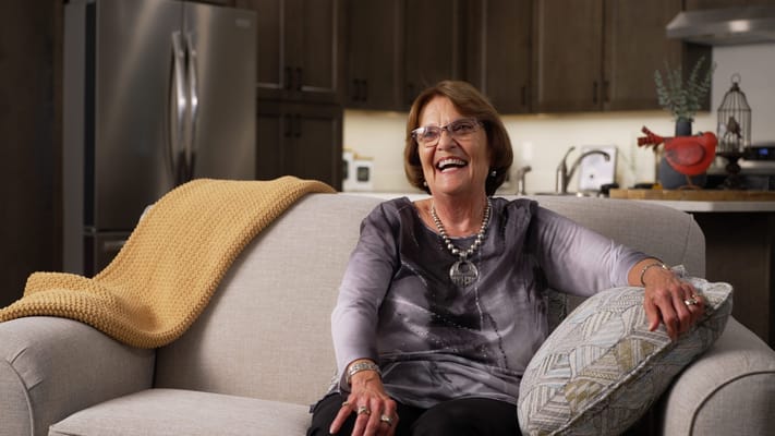 A cheerful resident sitting on a couch