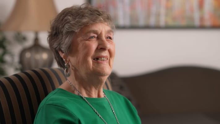 A smiling resident enjoying a moment indoors