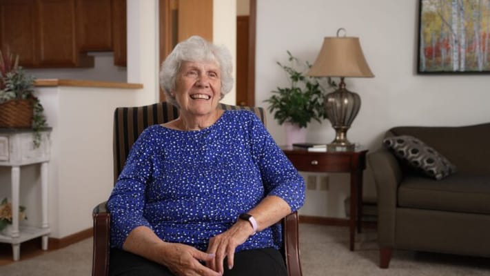 Resident smiling in a comfortable living room