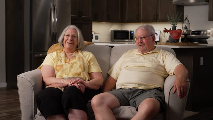 Two residents sitting comfortably in a cozy living area