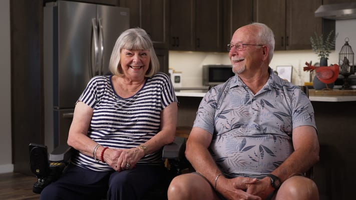 Two residents enjoying a conversation in a cozy interior setting