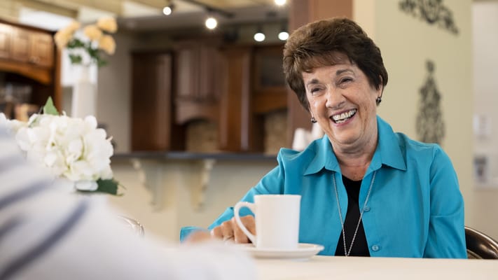 Resident enjoying a cup of coffee in a warm environment
