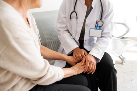 A caregiver holding hands with a senior resident