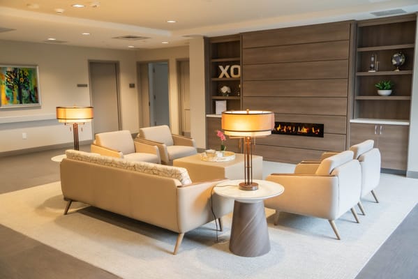 Cozy lounge area with modern seating and a fireplace