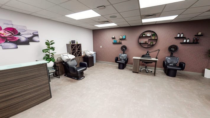 Beauty salon area with chairs and workstations