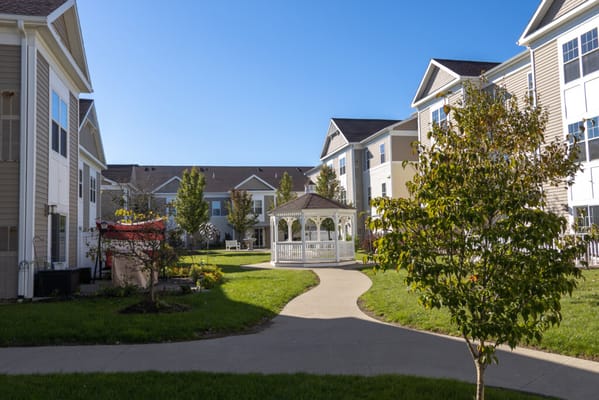Pathway leading to a gazebo in a landscaped courtyard