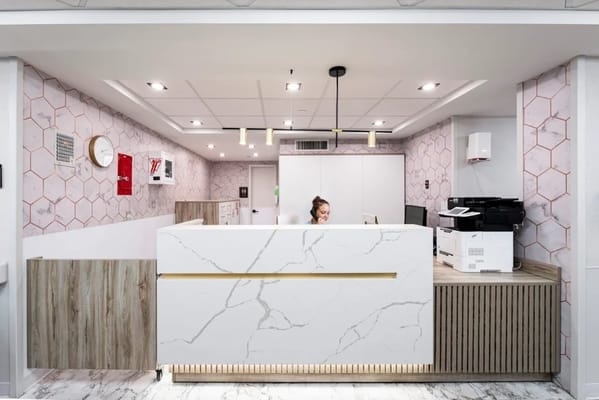 Reception area with staff member at a modern front desk