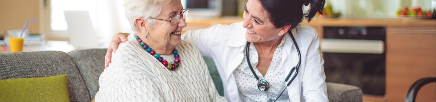 Caregiver and resident sharing a warm moment in common area