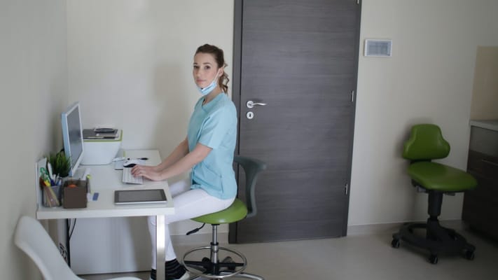 Care staff member at a workstation in a facility room