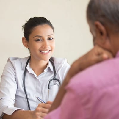 Healthcare professional talking with a resident