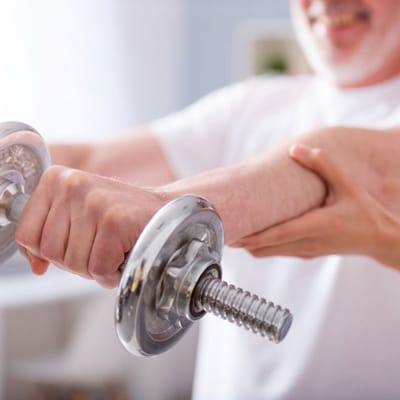 A senior engaging in strength training with assistance