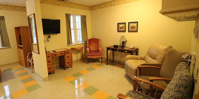 Cozy interior of a resident's room with seating areas