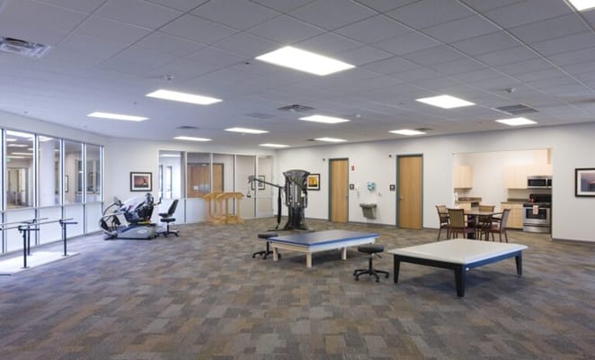Spacious physical therapy room with exercise equipment