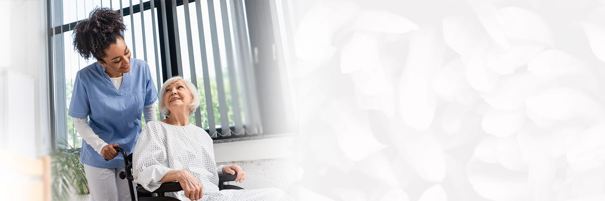 A caregiver assisting a resident in a bright indoor space