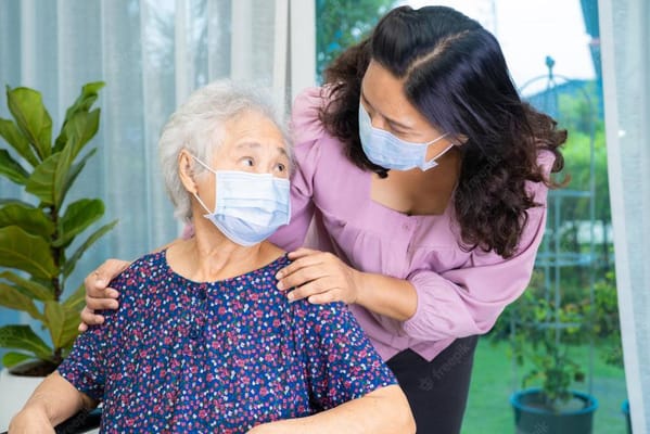 Caregiver interacting warmly with a senior.