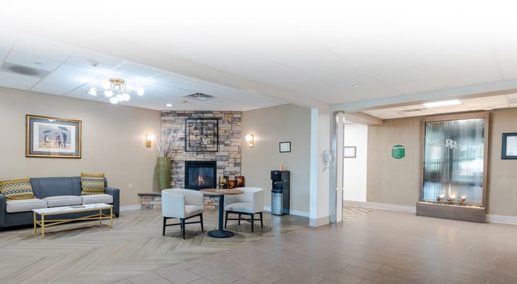 Bright lobby area with seating and fireplace