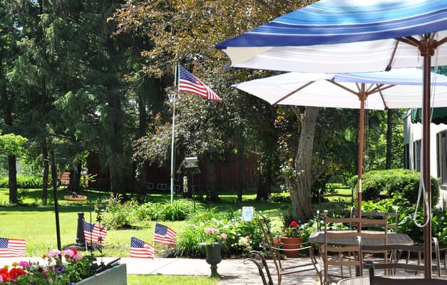 Garden area with American flags and umbrellas