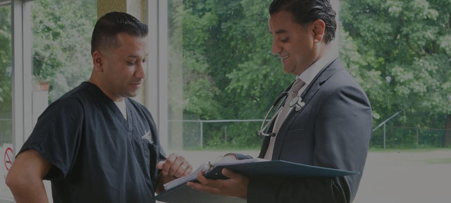 Medical staff discussing care in a facility interior