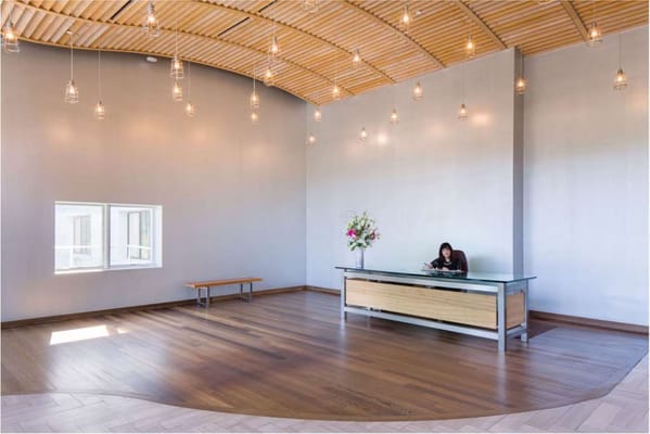 A bright lobby area with a reception desk