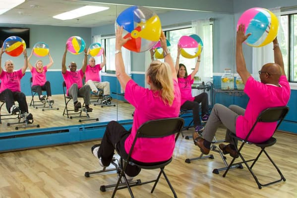 Residents engaged in an exercise activity with beach balls
