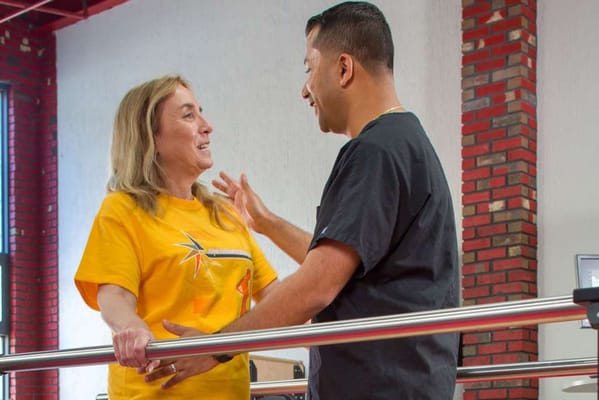 A resident interacting with a staff member during therapy