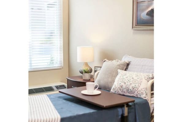 Cozy resident room with lamp and bedside table