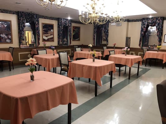 Dining area with covered tables and flowers