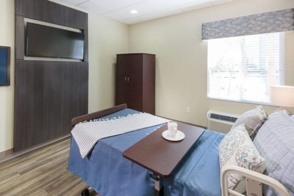 Private resident room with a bed and TV