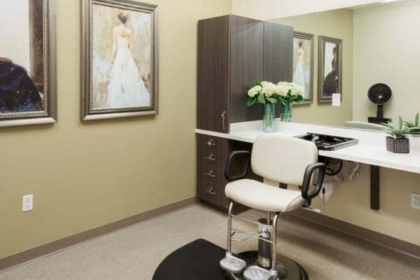 Beauty salon area with styling chair and mirrors