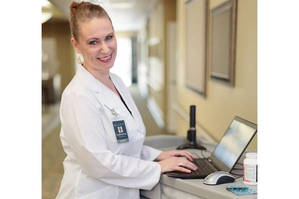 A staff member working on a laptop in the facility