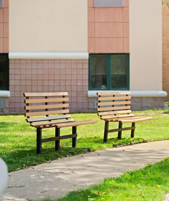 Benches in a grassy outdoor area near the building