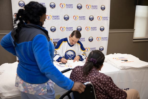 Residents participating in an engaging activity with a guest