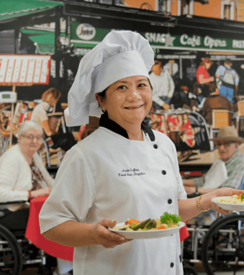Chef serving meals in a vibrant dining room